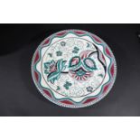 POOLE POTTERY CHARGER - DAVIES a large charger painted with a purple and green Art Deco style floral