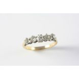 A DIAMOND FIVE STONE RING set with five graduated circular old cut diamonds, in yellow gold. Size O