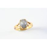 A STAR SAPPHIRE RING the oval-shaped star sapphire is mounted in gold. Size M