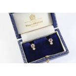 A PAIR OF DIAMOND STUD EARRINGS each set with a circular-cut diamond in gold collet setting,