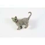 A DIAMOND CAT BROOCH realistically formed, set overall with circular-cut diamonds, with emerald