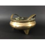 CHINESE BRASS CENSER Xuande mark but later, of two handled, circular, tripod form, cast mark,