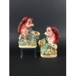 PAIR OF STAFFORDSHIRE SQUIRREL SPILL VASES mid 19th century, perched on branches, height 16cm (2)