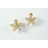 A PAIR OF DIAMOND FLOWERHEAD CLIP EARRINGS each earring set with a circular-cut diamond within a