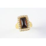 AN ANTIQUE GARNET AND PEARL CLUSTER RING the rectangular cabochon garnet is set within a surround of