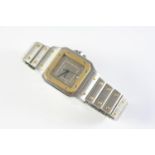 A GENTLEMAN'S STAINLESS STEEL AND GOLD SANTOS WRISTWATCH BY CARTIER the signed square shaped dial