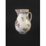 COOKWORTHY BRISTOL PORCELAIN MASK JUG painted with floral sprays beneath a moulded mask spout and