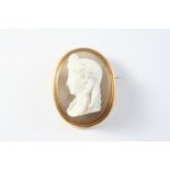 A VICTORIAN CARVED HARDSTONE CAMEO BROOCH depicting the profile of a young girl with flowing hair,