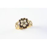 A VICTORIAN BLACK ENAMEL, PEARL AND GOLD RING the central section of black enamel with applied