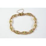 A 15CT GOLD AND TURQUOISE BRACELET each oval-shaped link is mounted with a flowerhead set with a