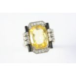 A YELLOW SAPPHIRE, DIAMOND AND BLACK ONYX RING the cushion-shaped yellow sapphire weighs 10.17