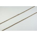 A VICTORIAN 9CT GOLD MUFF CHAIN formed with hammered circular links, 85cm long, 21.2 grams