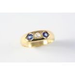 A SAPPHIRE AND DIAMOND THREE STONE RING the gold band is set with a cushion-shaped diamond and two