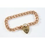 A 9CT GOLD CURB LINK BRACELET with 9ct gold padlock clasp, each link marked for 9ct gold, 19.5cm