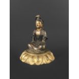 CHINESE GILT AND LACQUERED WOOD FIGURE OF GUANYIN possibly late Ming, seated on a lotus base, height