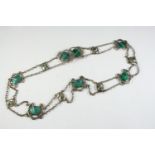 AN ART NOUVEAU ENAMEL AND SILVER NECKACE BY LIBERTY & CO formed with seven silver openwork panels