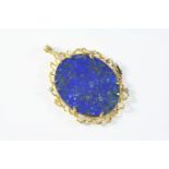 A LAPIS LAZULI, DIAMOND AND GOLD PENDANT the oval-shaped lapis lazuli is set within a gold geometric