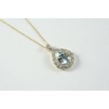 AN AQUAMARINE AND DIAMOND CLUSTER PENDANT the pear-shaped aquamarine is set within a surround of