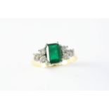 AN EMERALD AND DIAMOND RING the rectangular-shaped emerald is set with three circular-cut diamonds