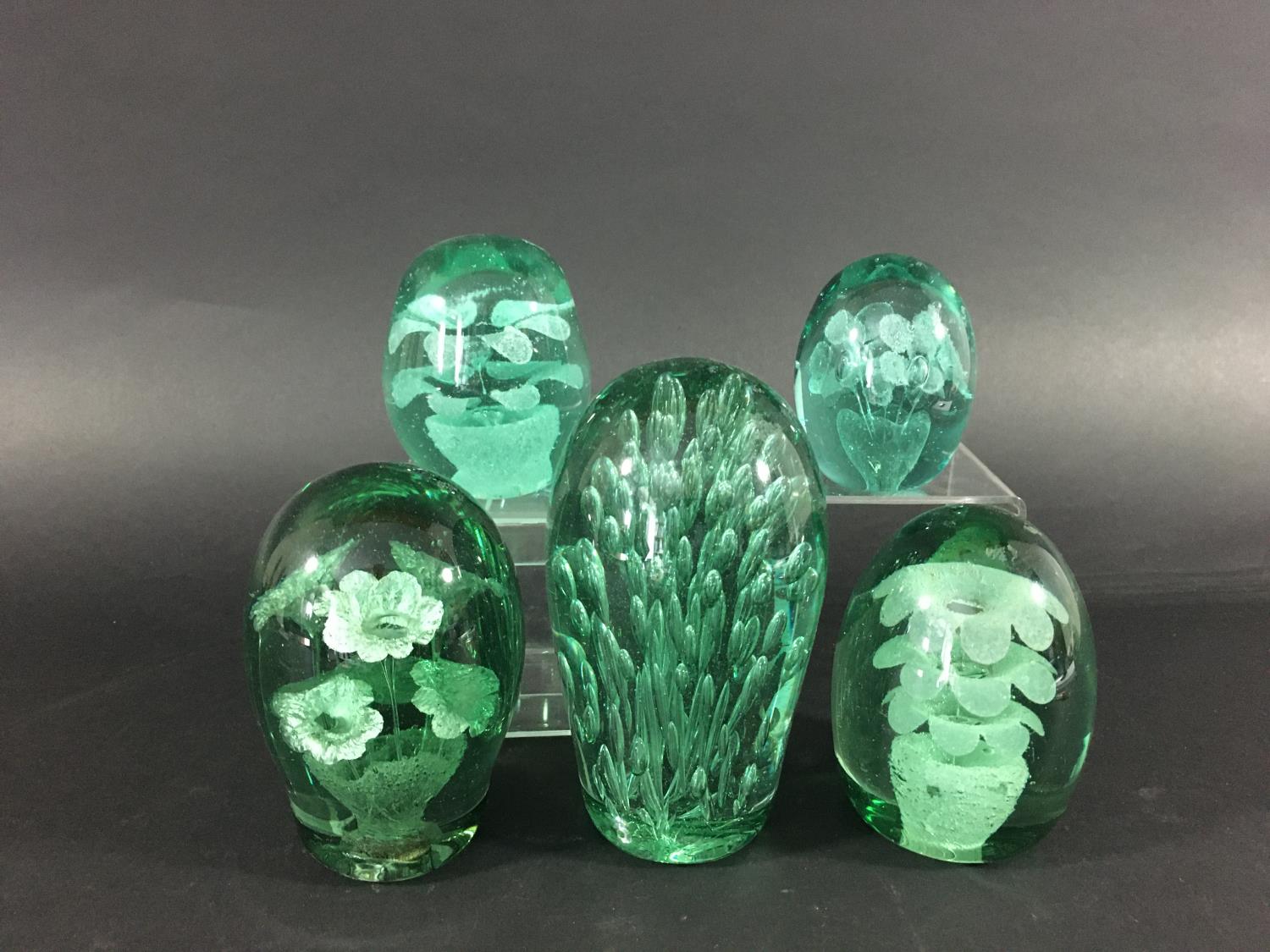 FOUR GREEN GLASS DUMPS possibly Kilner, each with pots of flowers, 12.5cm to 8cm; together with