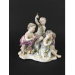 MEISSEN PUTTI GROUP 19th century, emblematic of Spring, the four children with garlands of flowers