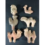 SOUTH EAST ASIAN TERRACOTTA ANIMALS to include two bactrian camels, a horse and rider, chicken, a