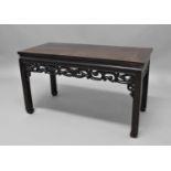 CHINESE HARDWOOD TABLE with scrolling, pierced aprons and moulded, square section legs, height 53cm,