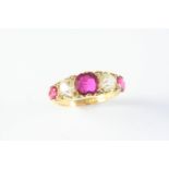 A RUBY AND DIAMOND FIVE STONE RING the three cushion-shaped rubies are set with two cushion-shaped