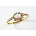 AN OPAL AND DIAMOND HALF HINGED BANGLE the gold openwork bangle mounted with an oval solid white