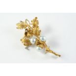 A GOLD, DIAMOND AND CULTURED PEARL FOLIATE SPRAY BROOCH the 18ct gold textured foliate mount is