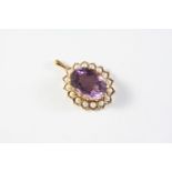 AN AMETHYST AND PEARL CLUSTER PENDANT the oval-shaped amethyst is set within a surround of half