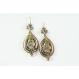 A PAIR OF PERIDOT DROP EARRINGS each earring set with a pear-shaped peridot and two circular-cut