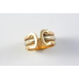 A 18CT THREE COLOUR GOLD RING BY CARTIER formed with three bands of gold with initial C to the