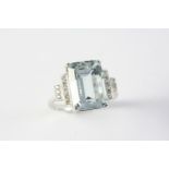 AN AQUAMARINE AND DIAMOND RING the step-cut aquamarine is set with two rows of circular-cut diamonds