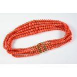 AN ANTIQUE FIVE ROW GRADUATED CORAL BEAD NECKLACE the coral beads graduate to a gold clasp mounted