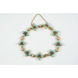 A TURQUOISE, RUBY AND PEARL BRACELET formed with nine quatrefoil clusters each centred with a