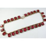 AN ANTIQUE RED PASTE AND PINCHBECK NECKLACE formed with rectangular-shaped red paste stones each