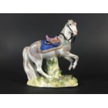 MEISSEN REARING HORSE mid 18th century, with a saddle and gilt lined numnah, on a floral encrusted