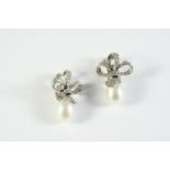 A PAIR OF DIAMOND AND CULTURED PEARL CLIP EARRINGS each earring set with a cultured pearl drop