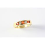 AN ORANGE SAPPHIRE AND DIAMOND FIVE STONE RING the three circular-cut orange sapphires are set