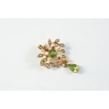 AN EDWARDIAN PERIDOT, RUBY AND PEARL BROOCH PENDANT centred with a circular-cut peridot within an
