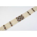 A CULTURED PEARL, DIAMOND AND RUBY CHOKER the lattice design cultured pearl choker is mounted with