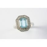 AN AQUAMARINE AND DIAMOND CLUSTER RING the octagonal-shaped aquamarine is set within a surround of