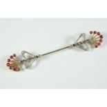 AN ART DECO RUBY AND DIAMOND JABOT PIN set with rose-cut and circular old-cut diamonds, the