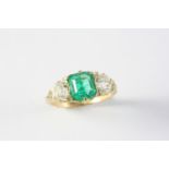 AN EMERALD AND DIAMOND THREE STONE RING the octagonal-shaped emerald weighs 1.71 carats and is set