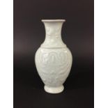 CHINESE CELADON BALUSTER VASE of flattened form decorated in low relief with ruyi and taotie
