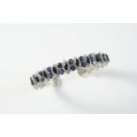 A SAPPHIRE AND DIAMOND BRACELET formed with marquise-shaped sapphire and diamond clusters, each