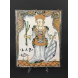 CONTINENTAL FAIENCE PLAQUE probably Nevers, France, painted with a portrait of St Lawrence holding a