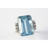 AN AQUAMARINE AND DIAMOND RING the step-cut aquamarine is set with three circular-cut diamonds to