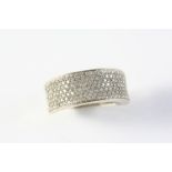A DIAMOND HALF HOOP RING set to one side with seven rows of circular-cut diamonds weighing